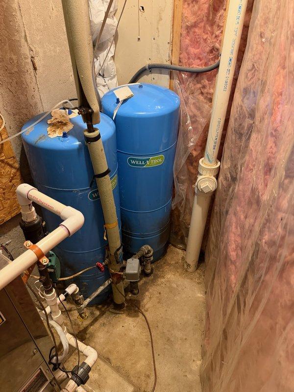 Replaced worn twist-style gate valves with lever-style ball valves on the main water line in the mechanical room near the well pressure tanks. Additionally replaced deteriorated tee fittings adjacent to the pressure tank to ensure proper water flow and system integrity. All connections were tested for leaks and proper operation upon completion.