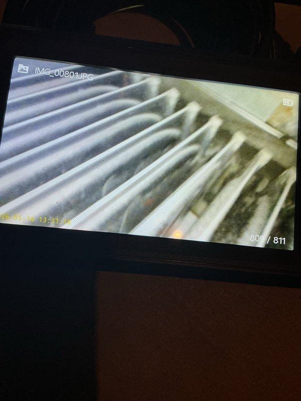 Performed annual air conditioning maintenance tune-up on 15-year-old Bryant system. System was found to be low on refrigerant charge despite having refrigerant and dye added during previous service visit last year. Conducted leak detection inspection and identified active refrigerant leak at the A-Coil, evidenced by UV dye tracing from prior service. Documented system condition with photographs showing furnace unit and coil contamination. Advised customer that A-Coil replacement or full system replacement is required to restore proper operation and prevent continued refrigerant loss.