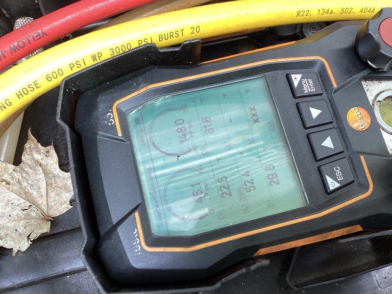 Completed rewards AC tune-up maintenance visit. Upon inspection, discovered oil residue on refrigerant line elbow in basement. Performed pressure diagnostics using manifold gauges, revealing low suction pressure at 47 psi (expected approximately 65 psi), indicating system is low on refrigerant despite achieving adequate temperature drop with 40° subcooling. Identified severely rusted evaporator coil drain pan with evidence of water leakage on floor around unit. Documented findings with photos of diagnostic equipment and pressure readings. Advised customer that system requires refrigerant charge and that rusted drain pan presents ongoing leak risk, recommending estimate for new AC system replacement due to age and condition of equipment.