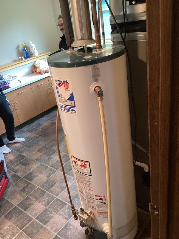 Completed annual plumbing inspection of residential property. Inspected Richmond Integra water heater installation, verified proper operation of temperature/pressure relief valve and discharge piping, confirmed copper supply and outlet connections are secure with no visible leaks, and documented unit condition with photographic records for maintenance history.