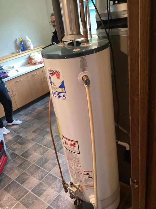 Completed annual plumbing inspection of residential property. Inspected Richmond Integra water heater installation, verified proper operation of temperature/pressure relief valve and discharge piping, confirmed copper supply and outlet connections are secure with no visible leaks, and documented unit condition with photographic records for maintenance history.