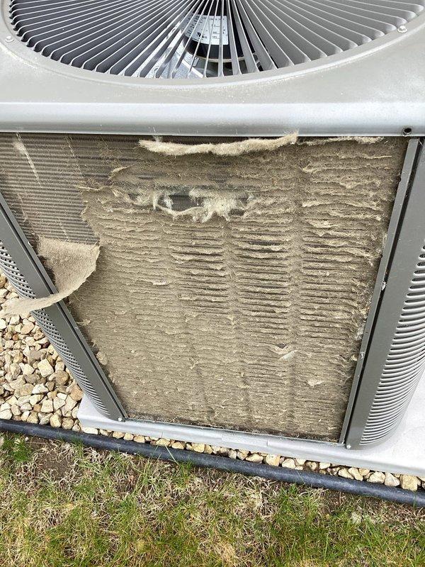 Completed annual AC tuneup and maintenance inspection on residential cooling system. Upon arrival, found outdoor condenser coil heavily soiled with dirt, dust, and debris accumulation affecting airflow and system efficiency. Cleaned condenser coil, inspected fan operation, and verified thermostat functionality showing proper temperature control at 69 degrees. All system components operating within normal parameters following maintenance service.