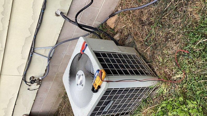 Responded to no cooling complaint on 1999 air conditioning system. Upon inspection, found evaporator coil completely blocked with pet hair and dander, restricting airflow and preventing adequate cooling performance. Thoroughly cleaned evaporator coil, removing all debris accumulation. System tested after cleaning showed 18° temperature split across coil, indicating improved but potentially marginal refrigerant charge. Unit now cooling adequately with restored airflow; however, given age of equipment and slight concern about refrigerant levels, system may require future monitoring or refrigerant adjustment if cooling performance degrades.