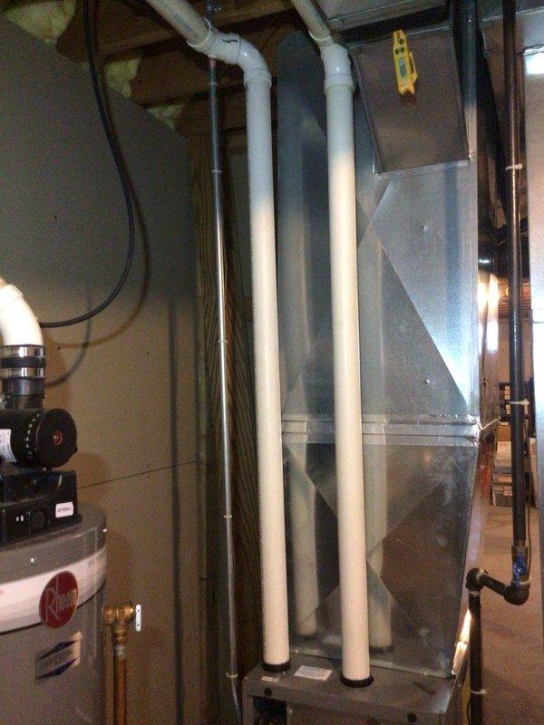 Performed comprehensive furnace and air conditioning tune-up for new customer with no known issues reported. Conducted full system inspection of both heating and cooling equipment. During inspection, identified a slow refrigerant leak along the bottom seam of the inducer assembly, attributed to age-related deterioration of the component. Documented the condition with photographs showing the FASCO inducer motor assembly and overall HVAC system configuration in the basement mechanical room. Informed customer of the inducer leak and provided a repair estimate for replacement of the component. Customer elected to defer inducer replacement at this time and will monitor the situation. Verified outdoor condensing unit is operating properly with adequate cooling performance. All other system components functioning within normal parameters. Completed tune-up maintenance procedures on both furnace and air conditioning systems.