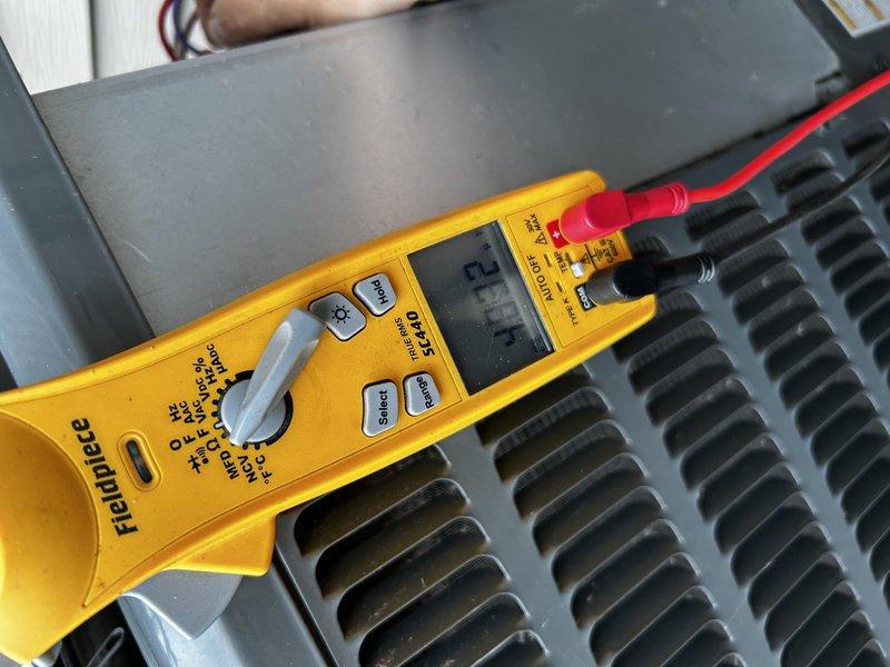 Performed comprehensive AC tune-up on 9-year-old system including operational testing, condenser coil cleaning, and verification of pressures, temperatures, and electrical components. System diagnostics revealed undercharged refrigerant condition; added 12 ounces of R-410A refrigerant and injected UV dye into system for future leak detection. Air filter confirmed clean and all components returned to proper operating parameters.