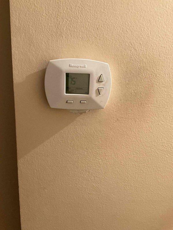 Responded to a no cooling call on an 11-year-old Bryant air conditioning system. Upon arrival, found the thermostat malfunctioning and the blower motor continuously running. Diagnostic testing revealed the system was significantly low on refrigerant charge. Customer reported detecting a refrigerant odor emanating from the indoor unit, suggesting a potential evaporator coil leak. Verified adequate airflow through the system and confirmed all mechanical components were functioning properly aside from the refrigerant loss. Discussed repair options with customer and scheduled a service advisor consultation to review replacement versus repair recommendations given the age of the equipment and suspected evaporator leak.