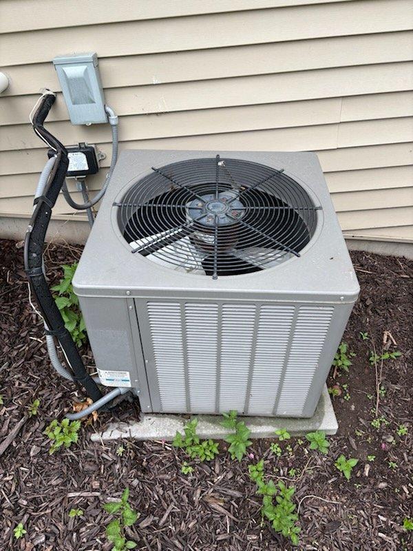Responded to no cooling complaint on 15+ year old residential air conditioning system. Upon arrival, discovered a gutter bracket had fallen onto the outdoor condensing unit during recent roof work, physically obstructing the condenser fan from spinning. Removed the foreign debris from the unit and verified fan operation. Performed complete electrical diagnostics on the system, confirming all voltage and amperage readings within manufacturer specifications. Measured supply and return air temperatures, verifying proper 20-degree temperature split across the evaporator coil. System restored to normal cooling operation with no additional repairs required.