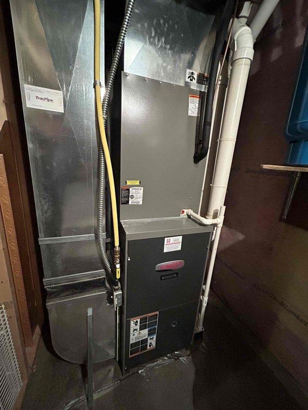 Completed comprehensive air conditioning maintenance tune-up on 14-year-old system. Inspected and tested capacitor and contactor, confirming both components operating within manufacturer specifications. Removed condenser coil access panels and performed coil cleaning by rinsing with water to remove debris and improve heat transfer efficiency. Verified new air filter installed, measured 20-degree temperature split across evaporator coil indicating proper refrigerant charge and airflow, confirmed evaporator coil sweating uniformly throughout, and checked condensate drain line for proper drainage with no blockages detected. All system components functioning properly with no deficiencies noted.