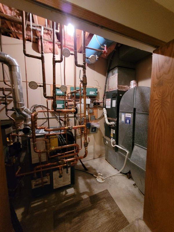 Responded to service call for leaking outdoor spigots and seasonal water system activation. Performed comprehensive plumbing inspection of mechanical room and utility systems. Identified outdated gate-style valves requiring replacement due to deterioration and active leaks. Successfully replaced compromised spigot assemblies with new fixtures and activated water supply to outdoor faucet system for seasonal use. Inspected copper supply lines, zone valves, and associated plumbing infrastructure throughout basement mechanical area. Verified proper operation of replacement spigots and confirmed no additional leaks present in water distribution system. All outdoor water access points now functioning properly with adequate flow and shutoff capability.