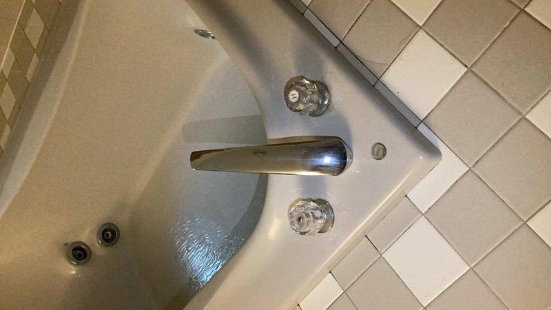 Responded to service call addressing multiple plumbing issues throughout the residence. Diagnosed and repaired Delta kitchen faucet experiencing reduced hot water flow, identifying a kinked supply line as the root cause. Assessed broken shower head in master bathroom where the tube fractured at the threaded connection point. Inspected Moen whirlpool tub faucet with active leak at handle assembly. Provided estimate for replacing shut-off valve under kitchen sink and repairing shower head assembly. Supplied separate estimate for complete whirlpool tub faucet replacement due to extent of wear and potential for continued leaking from handle mechanism.