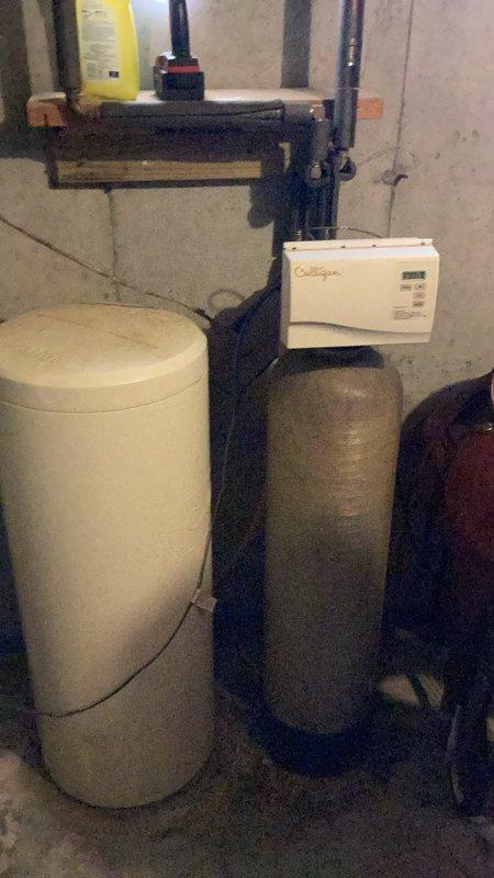Responded to water softener leak caused by hole in brine tank. Inspected dual-tank water treatment system and identified compromised brine tank requiring replacement. Documented existing installation with photos and provided estimate for new water softener unit.