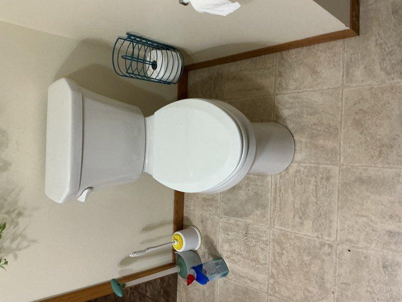 Responded to upstairs bathroom for clogged toilet caused by set of vehicle keys that had been accidentally dropped into the bowl. Provided customer with options for either attempting extraction and cleaning versus full toilet replacement. Customer elected to proceed with new installation. Removed existing toilet and installed new Gerber comfort height model. Successfully retrieved keys from base of old toilet during removal. Tested new installation for proper operation and verified no leaks present at water supply connection and floor flange seal.