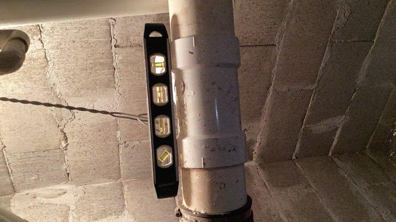 Responded to emergency water treatment system failure causing basement flooding. Successfully removed malfunctioning acid neutralizer unit from crawlspace that lacked bypass capability. Completed full repipe of water treatment system and installed new bypass configuration to allow future servicing without system shutdown. All PVC connections secured to concrete block walls with appropriate mounting hardware and tested for proper operation.