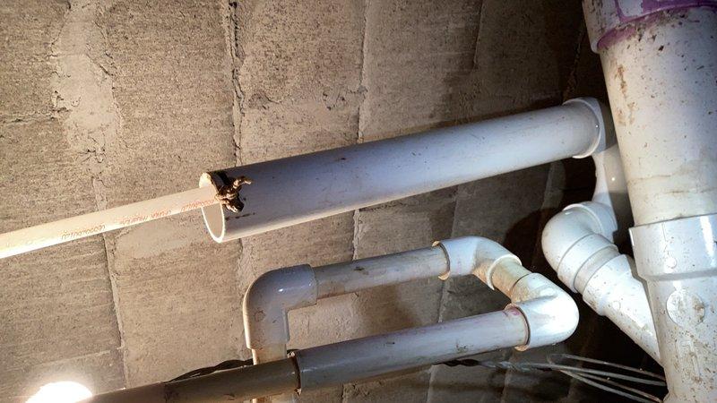 Responded to emergency water treatment system failure causing basement flooding. Successfully removed malfunctioning acid neutralizer unit from crawlspace that lacked bypass capability. Completed full repipe of water treatment system and installed new bypass configuration to allow future servicing without system shutdown. All PVC connections secured to concrete block walls with appropriate mounting hardware and tested for proper operation.