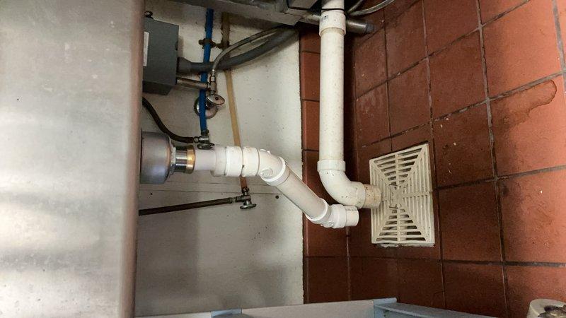 Responded to commercial kitchen plumbing issue where drain piping under food prep sink repeatedly disconnected from the strainer assembly. Upon inspection, determined the sink strainer was defective and causing the piping failure. Replaced the faulty strainer basket and reinstalled the P-trap configuration with new PVC drain piping to ensure secure, leak-free connections. System tested and confirmed operational with no further disconnections.