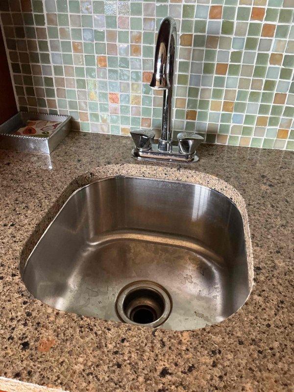 Completed comprehensive plumbing inspection of residential property and successfully replaced defective flush valve assembly in basement powder bathroom toilet, restoring proper flushing operation. Documented existing plumbing fixtures throughout property, including kitchen faucet and sink installations, with photographic records for maintenance history.