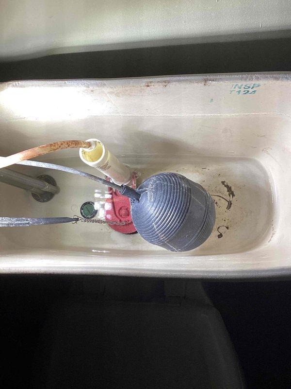 Responded to a two-toilet service call addressing clogging and leaking issues. The upstairs toilet had a deep clog and an improperly installed handle that spun 360 degrees, causing the chain to get sucked down the flushway. This resulted in the flapper sticking open and preventing the tank from refilling properly. Successfully augered the upstairs toilet to clear the obstruction and restore proper flushing function. 

The basement toilet exhibited active leaking due to corroded tank bolts and compromised seals. Performed a complete tank rebuild including replacement of the fill valve, tank-to-bowl gasket, and all tank mounting bolts. All components were properly installed and tested for leaks. Both toilets are now functioning correctly. Note: replacement handle for upstairs toilet was not available on truck and will require a follow-up visit to complete that portion of the repair.