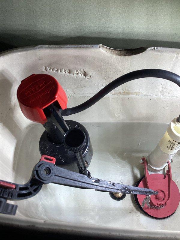 Responded to a two-toilet service call addressing clogging and leaking issues. The upstairs toilet had a deep clog and an improperly installed handle that spun 360 degrees, causing the chain to get sucked down the flushway. This resulted in the flapper sticking open and preventing the tank from refilling properly. Successfully augered the upstairs toilet to clear the obstruction and restore proper flushing function. 

The basement toilet exhibited active leaking due to corroded tank bolts and compromised seals. Performed a complete tank rebuild including replacement of the fill valve, tank-to-bowl gasket, and all tank mounting bolts. All components were properly installed and tested for leaks. Both toilets are now functioning correctly. Note: replacement handle for upstairs toilet was not available on truck and will require a follow-up visit to complete that portion of the repair.