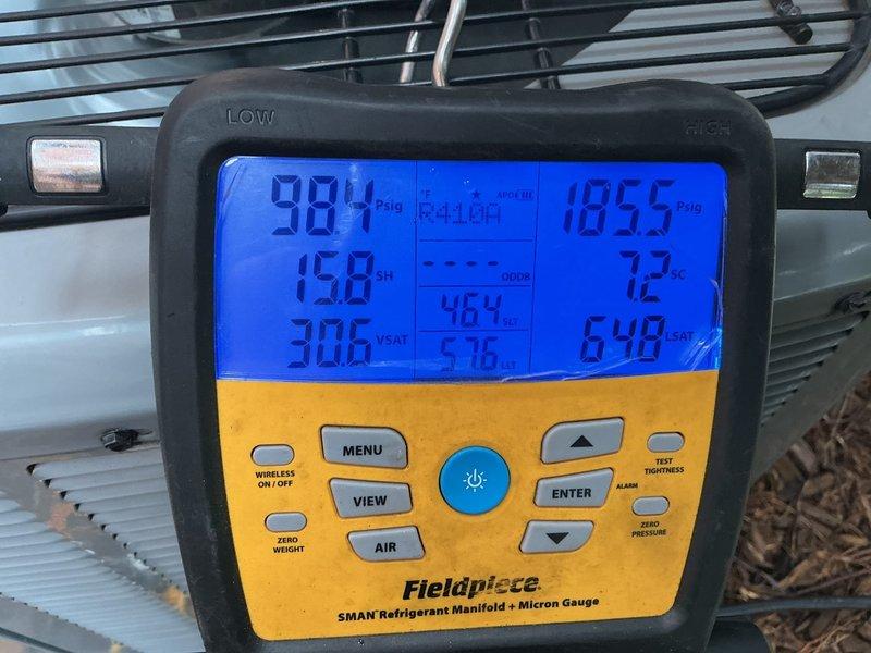 Responded to no cooling complaint on 5-year-old high velocity system. Performed system evaluation and measured refrigerant pressures using digital manifold gauges, obtaining readings of 984 PSIG low side and 1055 PSIG high side with 158°F superheat at outdoor temperature of 72°F. Confirmed cool air delivery from vents and determined refrigerant charge appears appropriate for current ambient conditions of 50°F outdoor temperature. Noted that accurate refrigerant charge verification on high velocity systems requires minimum 70°F outdoor ambient temperature for proper assessment. Documented previous capacitor substitution where 45/5 MFD unit was replaced with 55/5 MFD capacitor due to parts availability. Advised homeowner to operate system during warmer weather conditions and contact for follow-up evaluation if cooling issues persist when outdoor temperatures reach 70°F or above for accurate charge analysis.