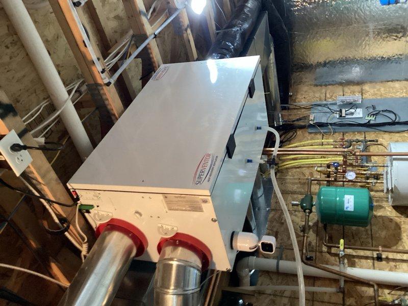Completed comprehensive maintenance tune-up on 19-year-old geothermal heat pump system per membership agreement. Performed system diagnostics revealing 26° supply temperature with 5° temperature rise across coil in cooling mode, with inlet pressure at 29 PSI and outlet pressure at 45 PSI, indicating proper operational parameters. Flushed condensate drain line, inspected and tested all capacitors and electrical components for proper function. Cleaned air exchanger filters and replaced Space Guard air filter with customer-supplied media. System operating within normal specifications at time of service completion.
