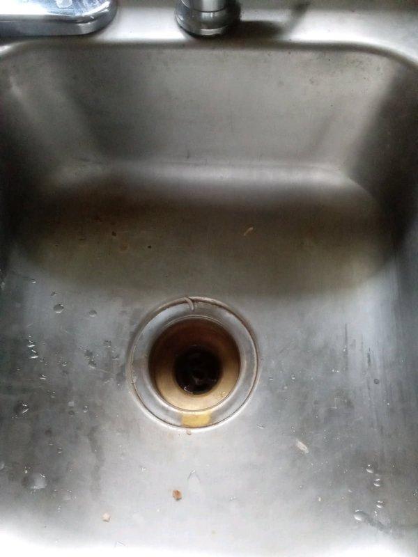Responded to service call for kitchen sink basket strainer inspection. Upon arrival, found existing strainer showing signs of wear with visible mineral deposits and discoloration around the drain assembly. Removed old basket strainer from sink basin and installed new replacement unit, ensuring proper seal and secure fit to prevent future leaks.