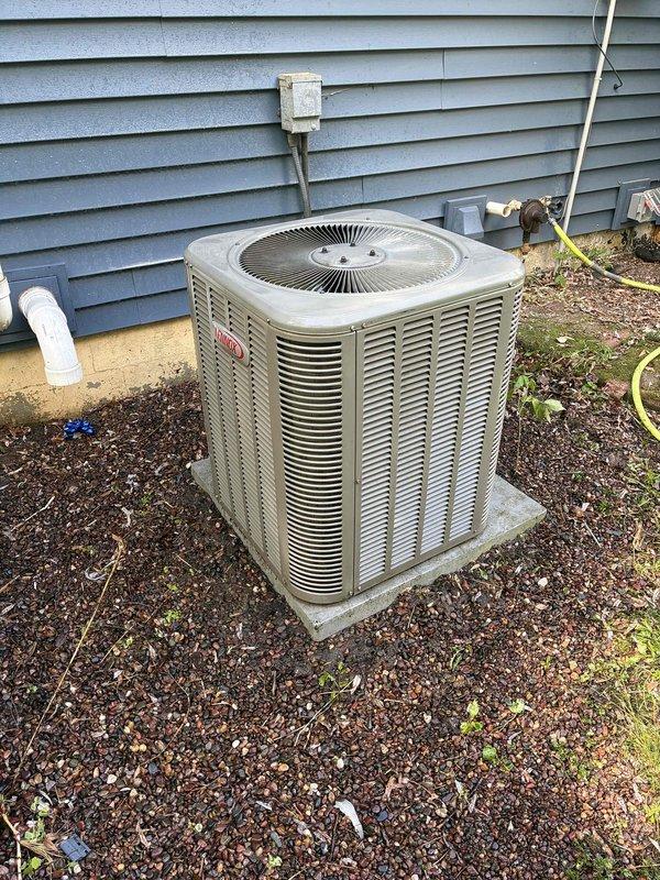 Responded to no cooling call on 10+ year old air conditioning system. Found condenser unit not running with high pressure switch tripped due to severely restricted airflow. Condenser coil was completely plugged with debris, preventing proper heat rejection and causing system shutdown. Reset high pressure switch and thoroughly cleaned condenser coil to restore airflow. Tested capacitor and contactor, both within acceptable parameters. Verified indoor air filter in satisfactory condition. System restarted successfully with 21-degree temperature differential across evaporator coil, confirming proper operation. Unit now cooling effectively and operating within normal parameters.
