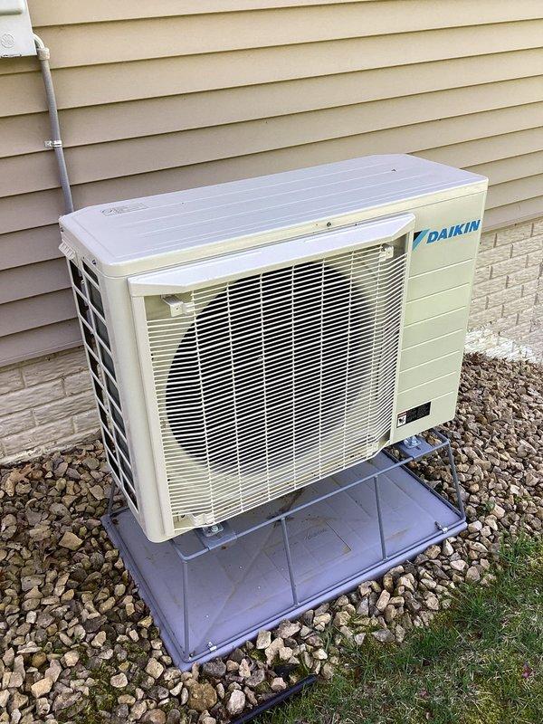 Completed preventive maintenance tune-up on 2-year-old Daikin heat pump system. Inspected indoor air filter and confirmed clean condition, verified outdoor condenser unit cleanliness and proper operation, and measured supply air temperature at 70.7°F. All components functioning within normal parameters with no deficiencies noted at time of service.
