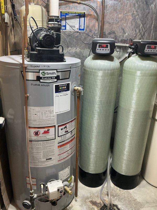 Responded to no cooling complaint on 12-year-old air conditioning system previously identified as low on refrigerant in April. Upon arrival, confirmed system was low on refrigerant and discovered indoor evaporator coil completely frozen, blocking all airflow to living space. Observed residual condensation leaking onto furnace cabinet, creating potential for secondary damage to heating equipment. System operating on obsolete refrigerant type. Set thermostat to off position and activated fan-only mode to initiate coil thaw process. Documented equipment condition with photographs showing HVAC installation and water damage concerns. Provided repair options via email and scheduled replacement system estimate. Confirmed furnace remains operational for heating needs during AC downtime.