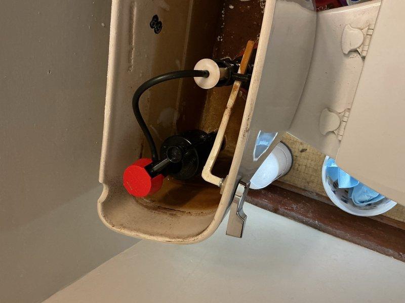Responded to a toilet issue in the main floor bathroom where an old-style fill valve was failing to shut off properly, causing continuous water flow. Removed the defective fill valve assembly and installed a new modern fill valve with adjustable float mechanism. Adjusted water level to manufacturer specifications to ensure proper tank filling and prevent overflow. Tested flush cycle multiple times to verify proper fill valve operation and complete shutoff. The toilet is now functioning correctly with no water waste or running issues.