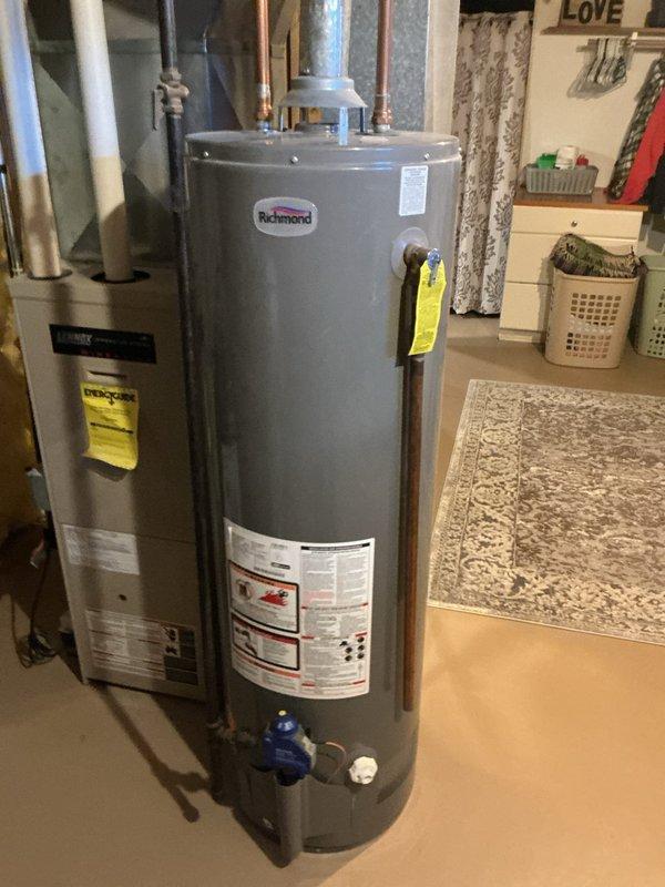 Responded to no hot water complaint and diagnosed failed gas valve on existing water heater. Removed and disposed of old unit, then installed new 40-gallon Bradford White gas water heater with standard atmospheric venting and 10-year warranty. Connected gas supply line, water supply and discharge piping, temperature and pressure relief valve with proper drainage, and verified all connections for leaks. Tested unit operation, confirmed proper ignition sequence, and ensured adequate combustion air and venting per manufacturer specifications.