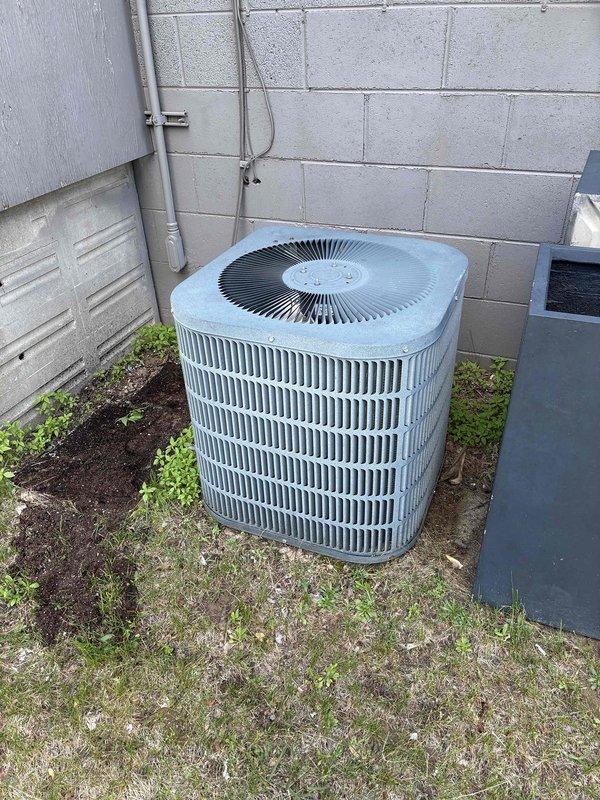 Responded to no cooling complaint at commercial property with two separate AC systems. First unit (1418 side): Found older R22 Goodman system with locked condenser fan motor and severely damaged fan blade; unit inoperable and requires replacement. Second unit (1416 side): Trane AC system not running due to loss of 24V power at furnace; discovered tripped rollout switch caused by cracked heat exchanger. Reset rollout to restore AC operation temporarily. Found condenser coil heavily plugged with debris, restricting airflow. Performed complete coil cleaning on Trane unit per customer approval, restored system to proper operation with 21-degree temperature differential across evaporator coil. Furnace tagged out due to failed heat exchanger presenting safety hazard; recommended immediate furnace replacement. Advised customer that R22 system requires full AC replacement due to failed motor and refrigerant phase-out. Provided estimates for all necessary repairs and replacements; awaiting buil
