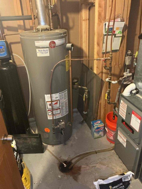 Completed comprehensive residential water line repipe including installation of new copper supply lines throughout the home. Work encompassed seven fixture locations: outside hose bibb, double laundry tub with deck-mount faucet and hot/cold washer connections, kitchen sink with dedicated shut-offs for dishwasher and ice maker, full bathroom rough-in for toilet, lavatory sink, and tub/shower valve with new single-handle chrome trim kit featuring multi-function handheld showerhead and slide bar, water heater supply and return connections, and main shut-off valve installation downstream of the water meter. All plumbing connections tested and verified operational with no leaks detected.