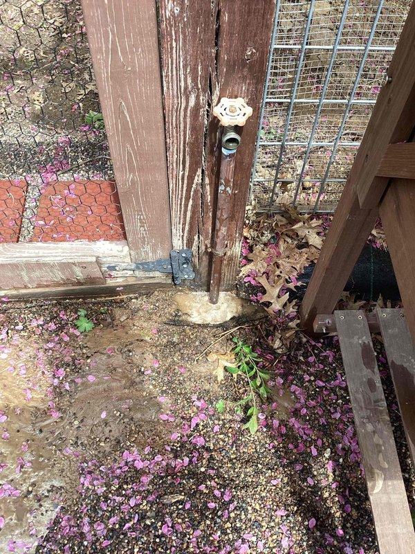 Responded to outdoor spigot leaking at the base near chicken coop area. Upon inspection, identified underground leak at spigot connection point. Documented existing conditions with photographs showing weathered fixture and surrounding area. Provided repair estimate to customer and submitted parts order form for necessary replacement components to address the underground leak.
