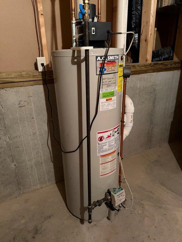 Responded to no hot water complaint on A.O. Smith power vent water heater that would not ignite and displayed error code indicating faulty gas valve driver circuit. Upon arrival, unit successfully ignited and ran during diagnostic evaluation. Performed thorough inspection of burner assembly, confirmed proper flame characteristics and combustion. Verified power vent system operation and checked exhaust venting for obstructions—found no blockages. Unit cycled normally and restored hot water to residence. Due to intermittent ignition failure history and gas valve driver circuit error code, provided estimates for gas valve replacement and full water heater replacement as preventative options to avoid future failures.