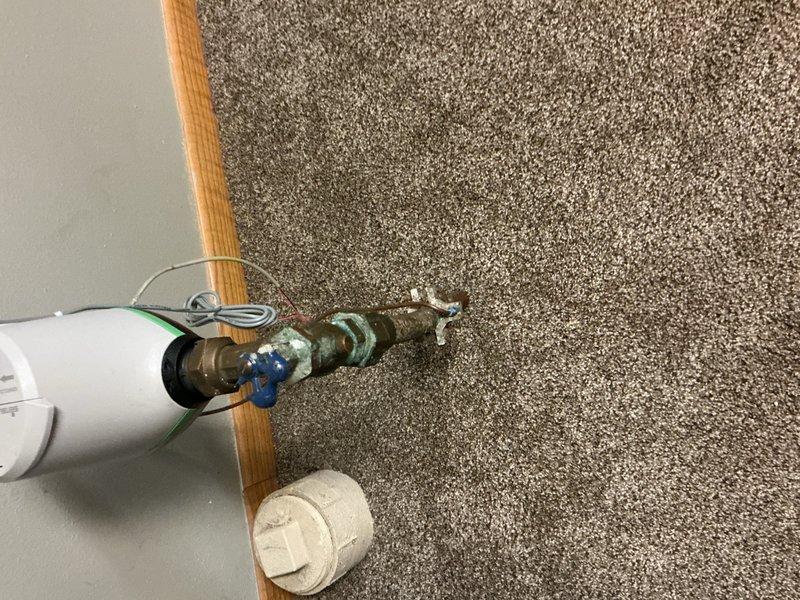 Responded to warranty call for exterior hose bibb that sustained freeze damage and was leaking during operation. Upon inspection, confirmed the outdoor faucet had frozen and cracked despite recent installation. Replaced the failed hose bibb with a new frost-proof sillcock, drilling through one floor joist to achieve proper drainage pitch and prevent future freeze damage. Advised customer that the main water shut-off valve before the meter shows signs of deterioration and will require replacement, to be scheduled at customer's convenience.