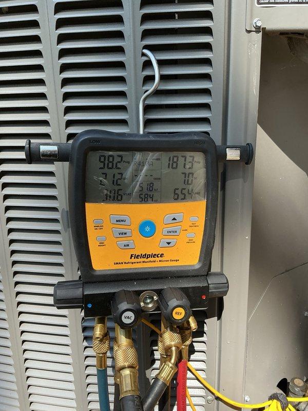 Performed comprehensive annual AC tune-up on 5-year-old system, verifying all indoor and outdoor components for optimal performance. Inspected furnace blower speeds and confirmed proper settings, checked air filter condition, tested all electrical components which measured within manufacturer specifications, performed coil cleaning by removing panels and rinsing condenser coils until clear, and flushed evaporator drain line to ensure proper drainage. Connected manifold gauges to verify refrigerant charge, confirmed system operating at proper levels with 22-degree temperature split across evaporator coil, and verified all components functioning correctly with no deficiencies noted.