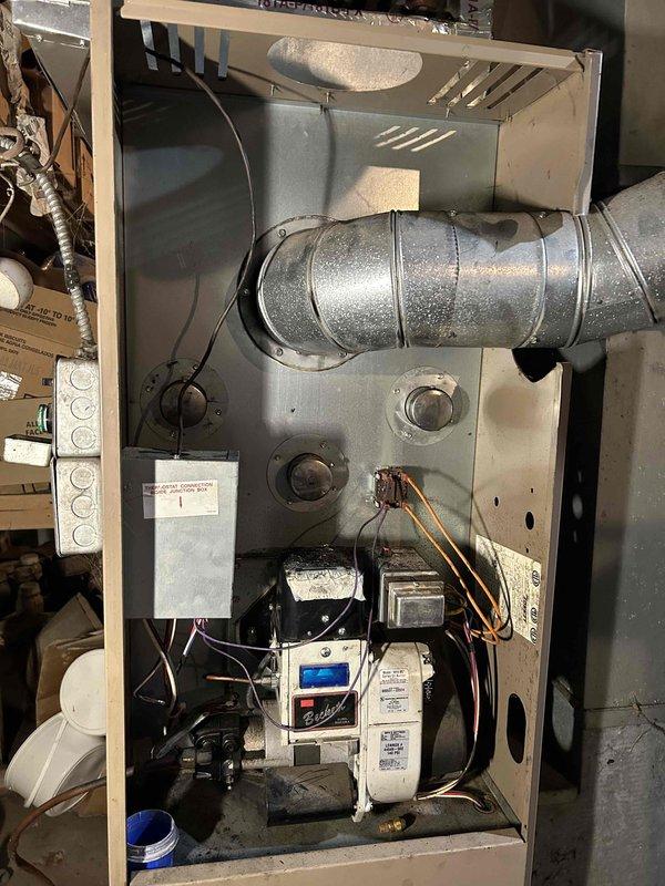 Performed comprehensive soot cleaning on oil furnace system due to excessive buildup affecting operation. Removed and thoroughly cleaned heat exchanger, disconnected and cleaned vent pipe from unit to chimney connection, and replaced faulty limit control. All components tested after reassembly with system now operating within normal parameters.