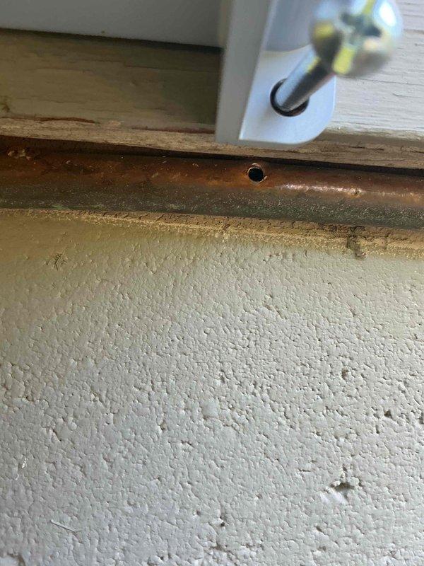 Responded to gas leak between meter and regulator caused by solar panel installation contractor drilling through copper gas line. Replaced damaged copper line section with new pipe and fittings. Replaced gas regulator that had been improperly positioned during solar work. System tested and restored to safe operation.