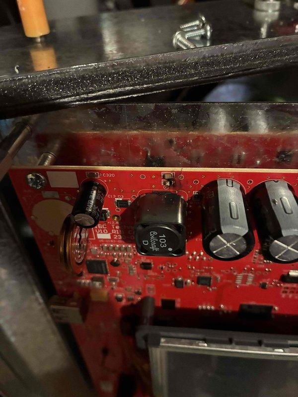Responded to no hot water condition on 6-month-old boiler. Found display board completely black despite power present at unit. Diagnostic testing revealed blown fuse and visible burn damage on display board. Performed inline fuse test to isolate fault, which indicated short circuit originating from SIM board component. When SIM board was reconnected during testing, inline fuse immediately failed, confirming board-level short circuit. Documented damage with photographs showing burnt components on red PCB and affected display assembly. Completed parts order form for replacement display board and SIM board required to restore operation. Unit remains non-operational pending parts arrival and reinstallation.