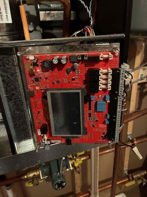 Responded to no hot water condition on 6-month-old boiler. Found display board completely black despite power present at unit. Diagnostic testing revealed blown fuse and visible burn damage on display board. Performed inline fuse test to isolate fault, which indicated short circuit originating from SIM board component. When SIM board was reconnected during testing, inline fuse immediately failed, confirming board-level short circuit. Documented damage with photographs showing burnt components on red PCB and affected display assembly. Completed parts order form for replacement display board and SIM board required to restore operation. Unit remains non-operational pending parts arrival and reinstallation.