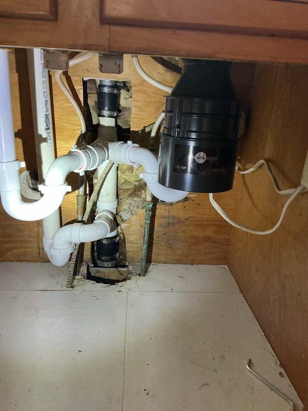 Responded to kitchen sink drainage issue caused by failed garbage disposal unit. Upon inspection, found 20-year-old disposal had ceased operation after attempting to grind potato skins. Removed old disposal unit and installed new garbage disposal, restoring full functionality to kitchen sink drain system. Verified proper operation and drainage upon completion.