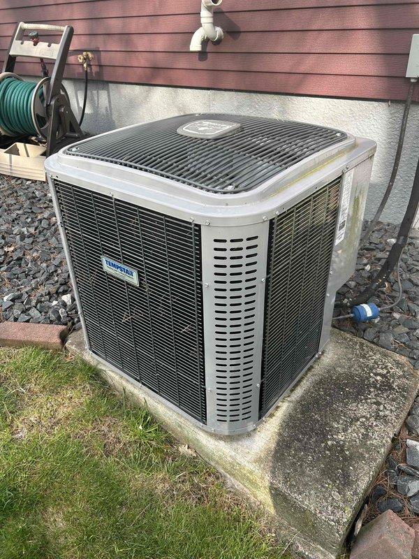Completed comprehensive air conditioning tune-up on 8-year-old residential system with no prior known issues. Tested all electrical components, verified specifications were within normal operating parameters, and rinsed condenser coil. Discovered rodent infestation in compressor jacket with active mouse presence; removed compromised jacket, extracted chewed insulation and debris (pine needles) from condenser area surrounding compressor, and disposed of damaged materials. Cleared condensate drain line and installed new air filter. System operating properly with 22-degree temperature split across evaporator coil, confirming optimal cooling performance.