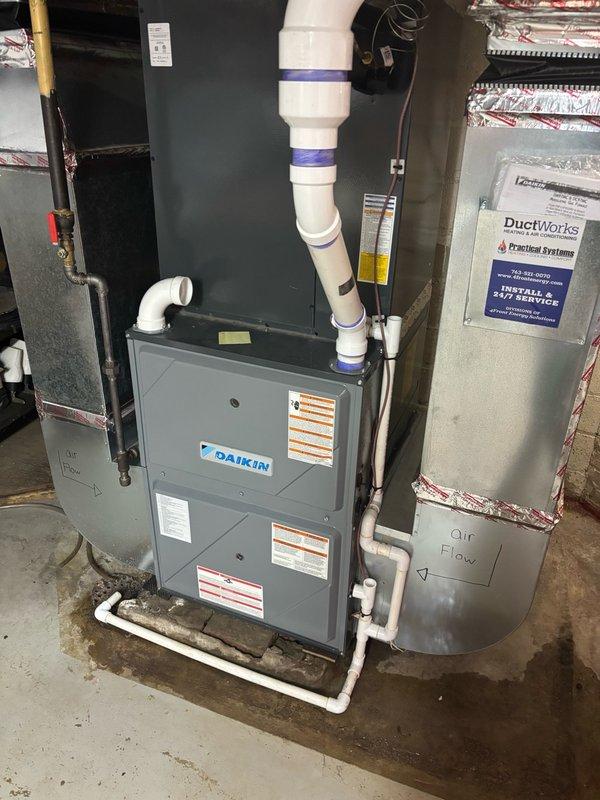 Responded to urgent water leak in furnace room affecting Rheem water heater and surrounding mechanical equipment. Upon arrival, water supply was already shut off by homeowner. Conducted systematic pressure test by slowly restoring water supply to identify leak source among multiple suspected areas. Located pinhole leak on hot water outlet pipe of water heater that had been spraying water throughout the mechanical room. Shut off water supply and performed repair by cutting out compromised section of copper piping and installing coupling to restore pipe integrity. Restored water supply and conducted 15-minute pressure monitoring to verify repair and check for additional leaks. No further leaks detected. Relit water heater pilot and verified proper operation before restoring system to full service.