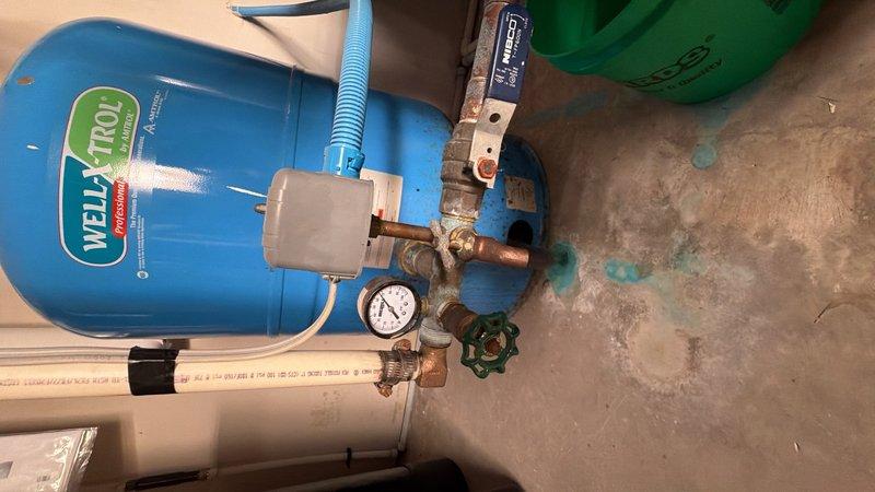 Completed comprehensive plumbing inspection of rough-in installation including PVC drain and vent piping systems in framed ceiling space, HVAC ductwork clearances, and well water pressure tank system with associated copper piping, brass fittings, pressure gauge, and PEX connections. All components inspected for proper installation, code compliance, and operational readiness prior to finish work.