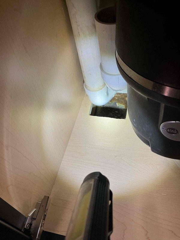 Responded to leaking conditions under kitchen sinks in two separate kitchen areas. Upon inspection, identified that 2-inch union traps connected to dishwasher drain lines were loose and causing water leakage in both locations. Tightened union fittings on both P-trap assemblies to manufacturer specifications, eliminating all active leaks. Verified proper drainage flow and confirmed no additional moisture present after repair completion.