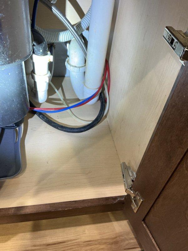 Responded to leaking conditions under kitchen sinks in two separate kitchen areas. Upon inspection, identified that 2-inch union traps connected to dishwasher drain lines were loose and causing water leakage in both locations. Tightened union fittings on both P-trap assemblies to manufacturer specifications, eliminating all active leaks. Verified proper drainage flow and confirmed no additional moisture present after repair completion.
