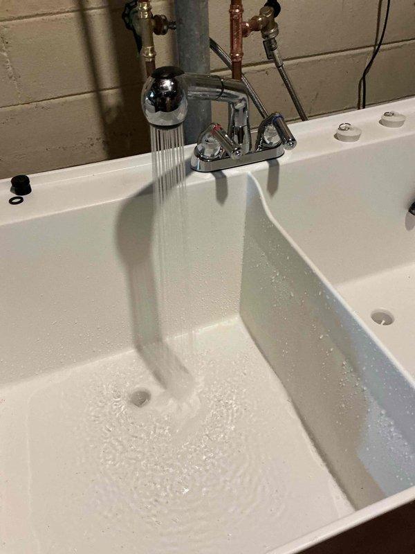 Installed customer-supplied faucets in two locations: a utility/laundry sink and a bathroom bathtub. Additionally, installed a sediment filter as requested to replace a damaged unit. All fixtures were tested and confirmed operational with proper water flow upon completion.