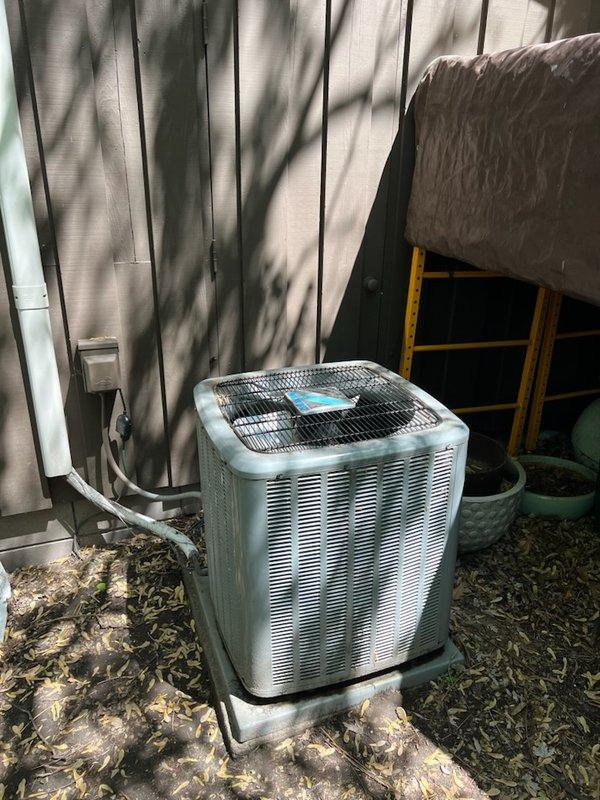 Performed preventive maintenance on a 5-year-old residential air conditioning system that failed to start due to excessive debris accumulation. The outdoor condenser unit, located near a park area, had significant buildup of leaves and cottonwood material restricting airflow through the coil and louvers. Thoroughly cleaned the exterior condenser unit, removing all organic debris from the coil fins, cabinet, and protective grille. Inspected all electrical components, refrigerant lines, and mechanical systems to ensure proper operation. After cleaning and component verification, successfully restored system functionality and confirmed normal startup and operation of both the outdoor condenser and indoor air handler units.