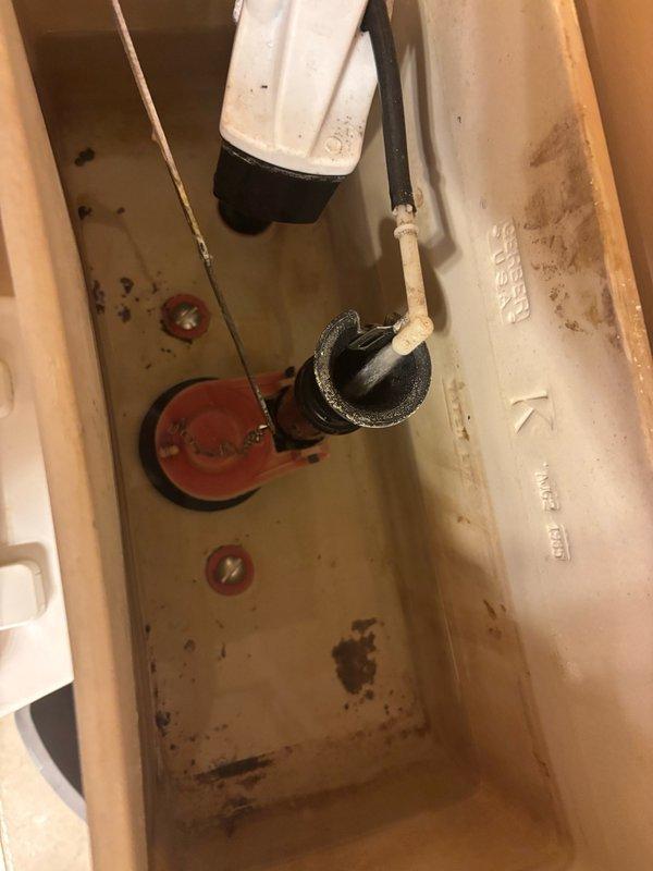 Responded to a reported leak from a master bathroom toilet tank. Upon arrival, found that the tenant had already tightened the tank-to-bowl mounting bolts, which appeared to have stopped the active leak. Inspected both tank bolts and confirmed proper tightness to ensure a watertight seal. Refilled the tank and conducted a 10-minute pressure test to verify no water seepage from either bolt connection. Both mounting points remained dry throughout the test period, confirming the leak was resolved through proper bolt tightening.