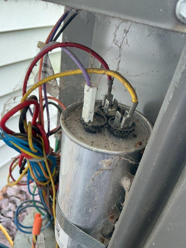 Responded to service call for air conditioning system not maintaining adequate cooling during hot weather conditions. Upon arrival, performed comprehensive AC tune-up and diagnostic evaluation of the cooling system.

Activated heating system to raise indoor temperature to 74 degrees to establish proper conditions for accurate refrigerant pressure and temperature measurements. Conducted refrigerant charge analysis, which indicated levels were within acceptable parameters.

Performed electrical diagnostics on outdoor condensing unit. Observed compressor operating with elevated amperage draw and excessive noise levels during operation. Inspected capacitor connections, noting significant corrosion and deterioration on terminal points with evidence of oxidation and burnt material around connection posts. Capacitor housing showed weathering consistent with extended outdoor exposure.

Monitored system performance metrics and identified concerning operational patterns. Vapor saturation tempera